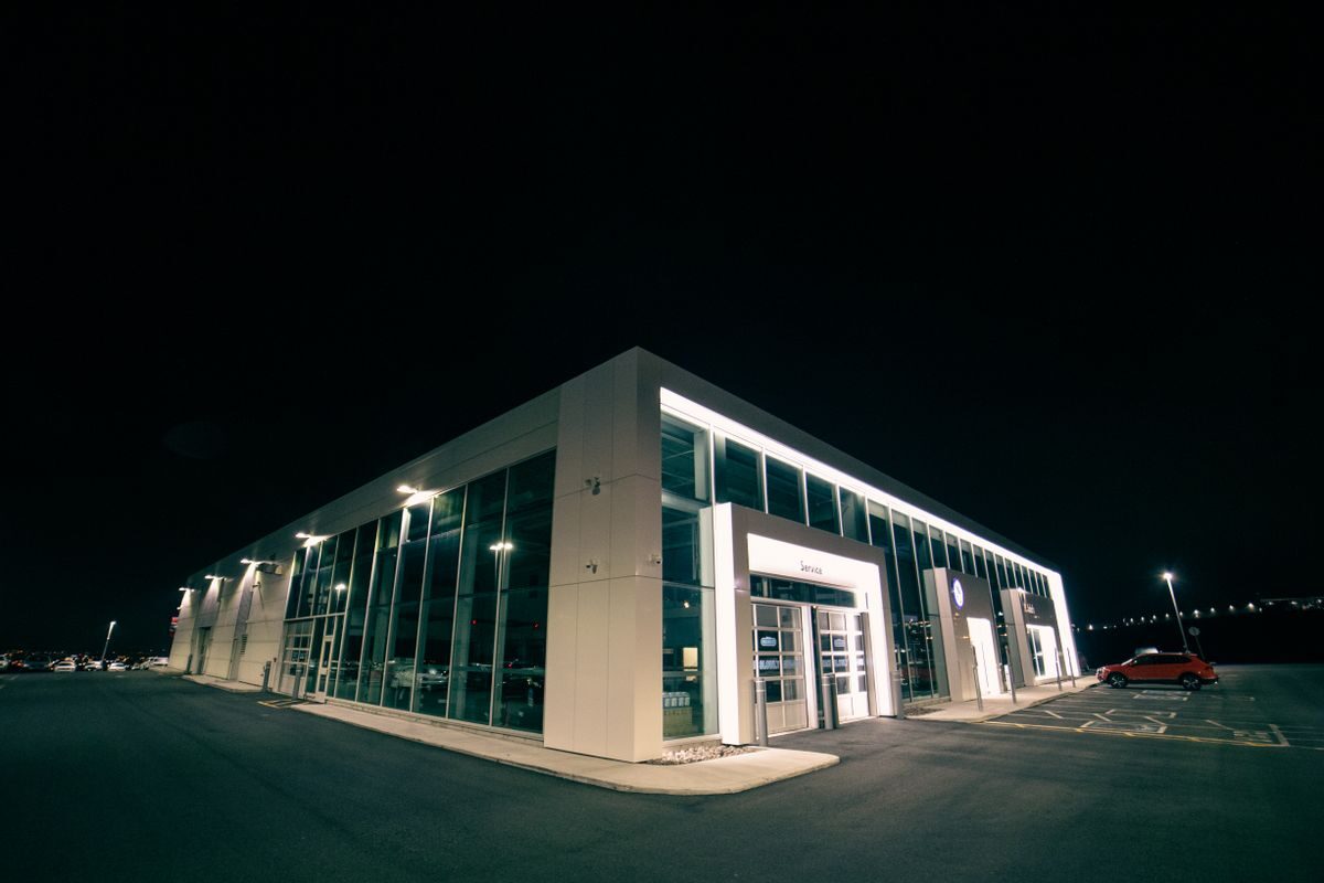 An illuminated car showroom at night