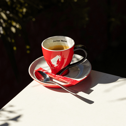 Red Julius Meinl cup and saucer on a sunny terrace